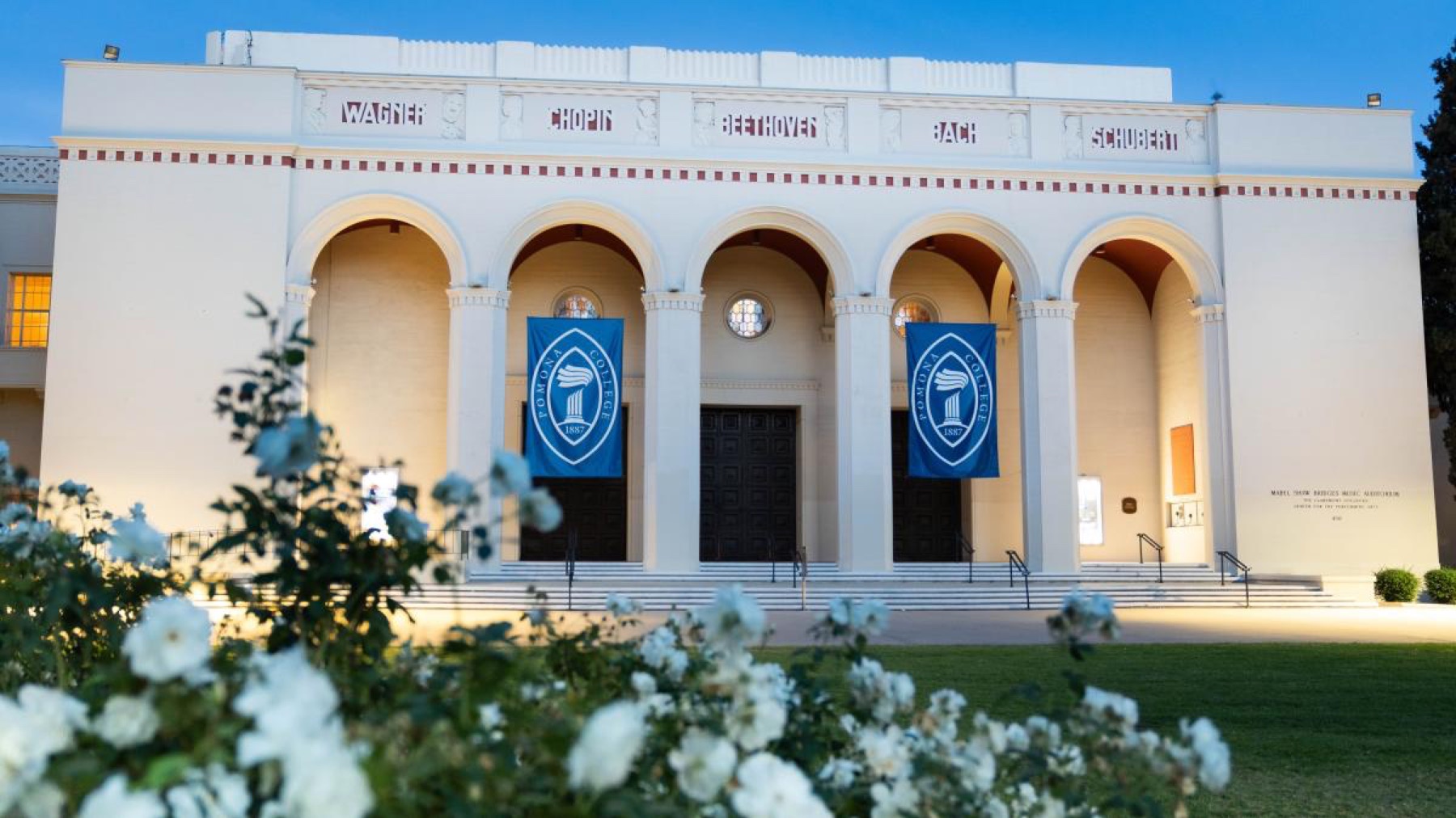 Bridges Auditorium at Pomona College with blue campus banners